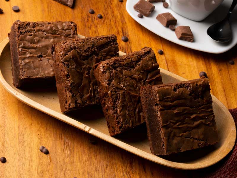 Four chocolate chip brownies on a plate