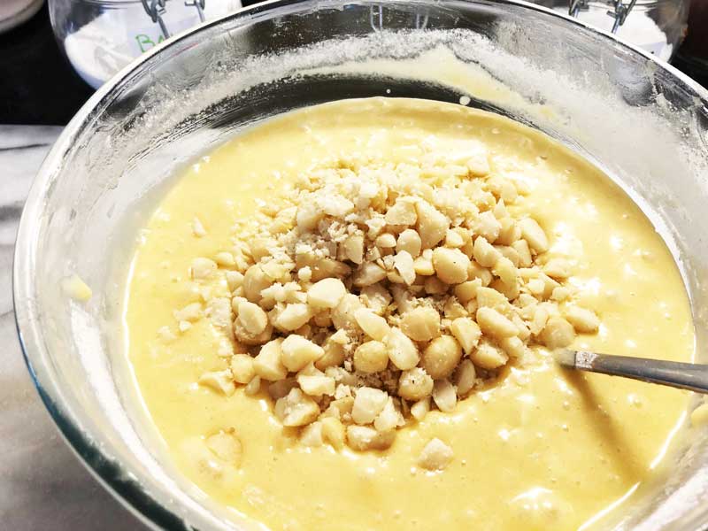 Stirring the macadamia nuts into the batter